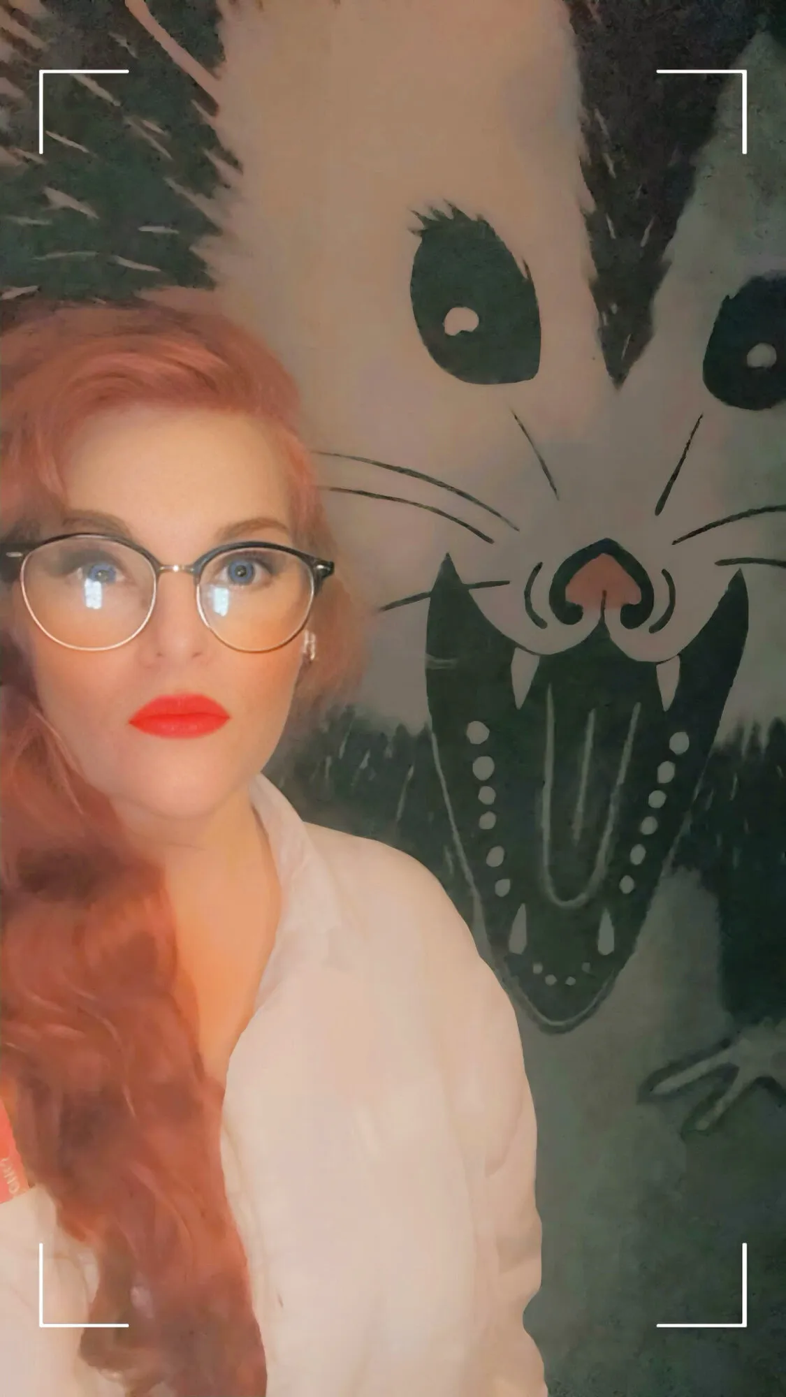 Scarlett Vox in front of a possum painting